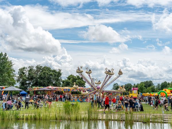 Families enjoying fairground rides and attractions at ESET Family Day 2024 in Malinovo